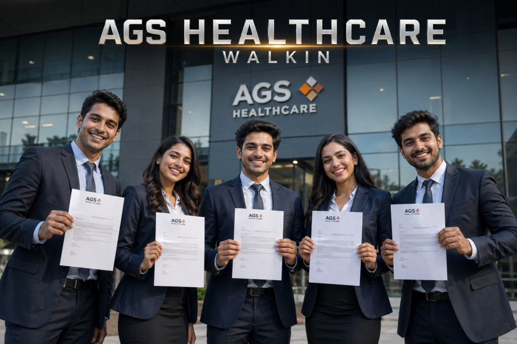 Group of young Indian professionals holding AGS Health offer letters outside corporate office during walk-in drive 2026